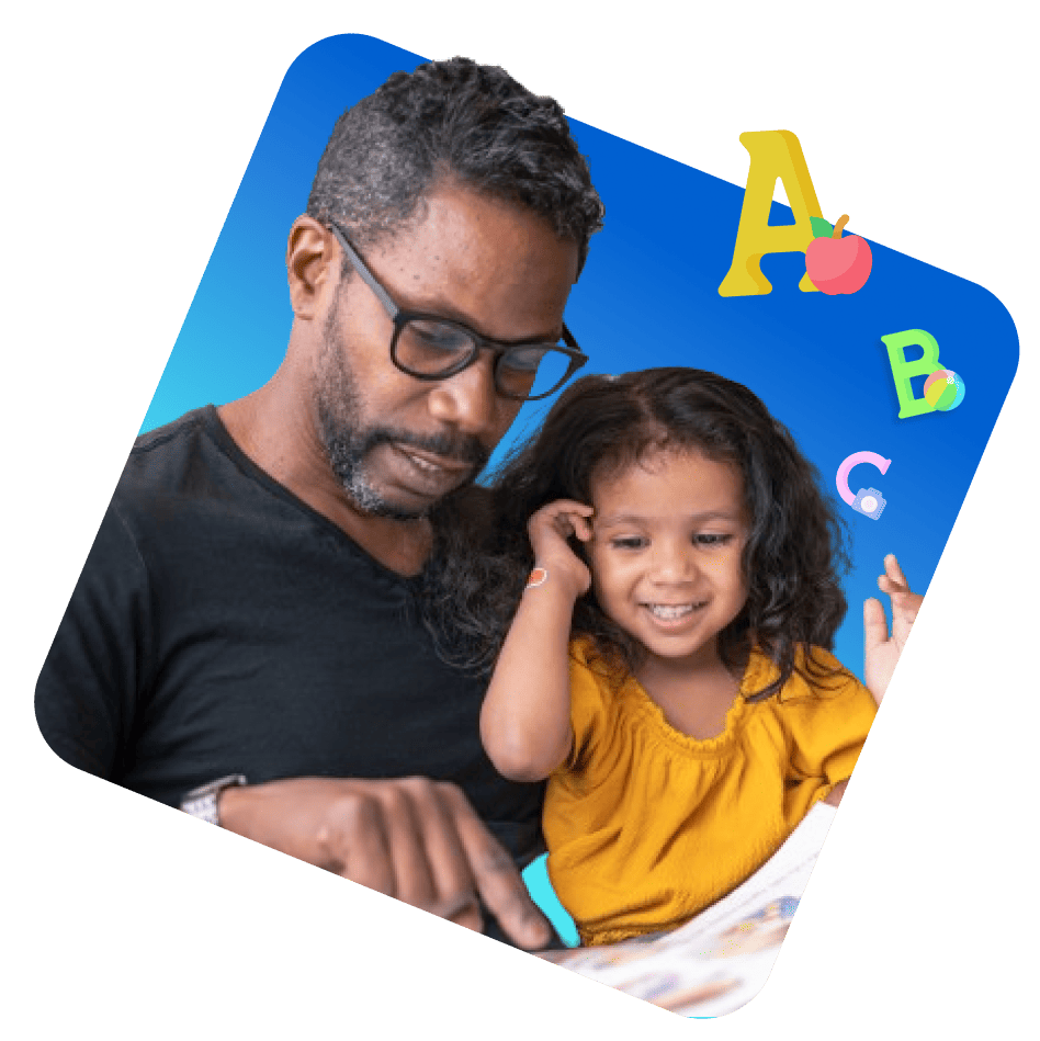 A man and a young girl sit together, engrossed in reading a book, sharing a moment of learning and joy.