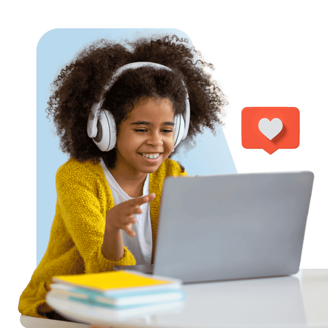 Young child with curly hair and headphones smiles at a laptop, gesturing in excitement. A digital heart icon floats nearby, with books on the table.