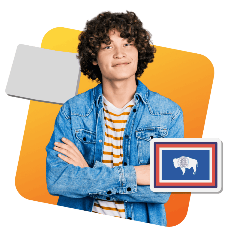 A boy with curly hair wearing a blue denim jacket stands in front of a flag featuring a bison design.