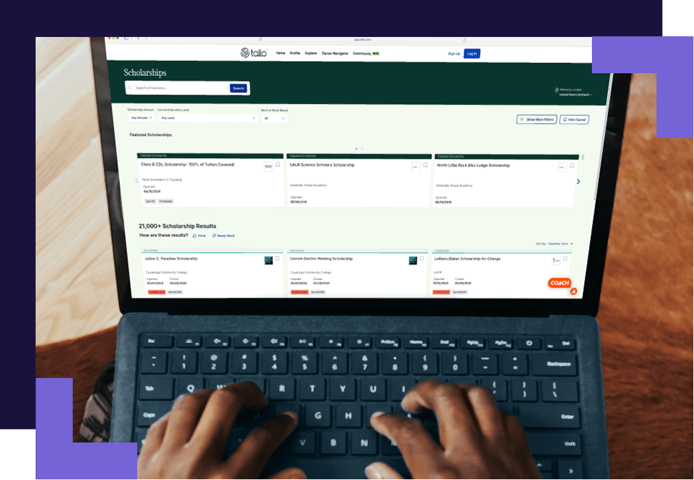 Hands typing on a laptop displaying a scholarship search webpage. The screen shows multiple scholarship listings organized with filters and search options.